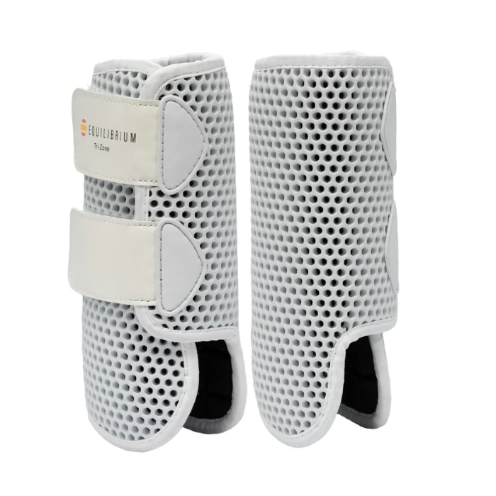 Pair of white protective horse boots with perforated surface and Equilibrium logo on a white background