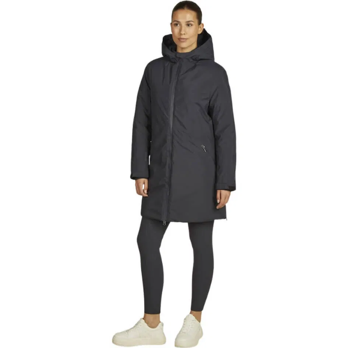 Person wearing a navy parka coat on a white background