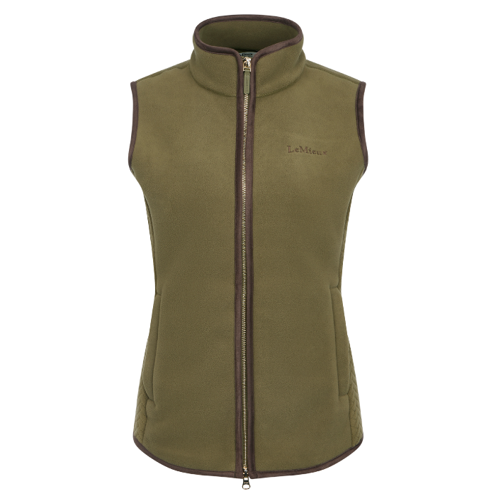 LeMieux AW26 Frankie Fleece Gilet Variant Colour Willow Green. 
An willow green fleece vest with dark brown trim, a full-length front zipper, and a small embroidered LeMieux logo on the left chest, shown against a plain white background.