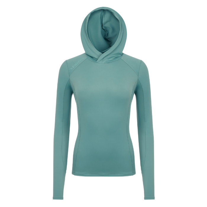 LeMieux AW26 Heidi Hooded Mid Layer Variant Colour Aloe.
A women's long-sleeve hooded athletic top in a muted, shown on a plain white background.