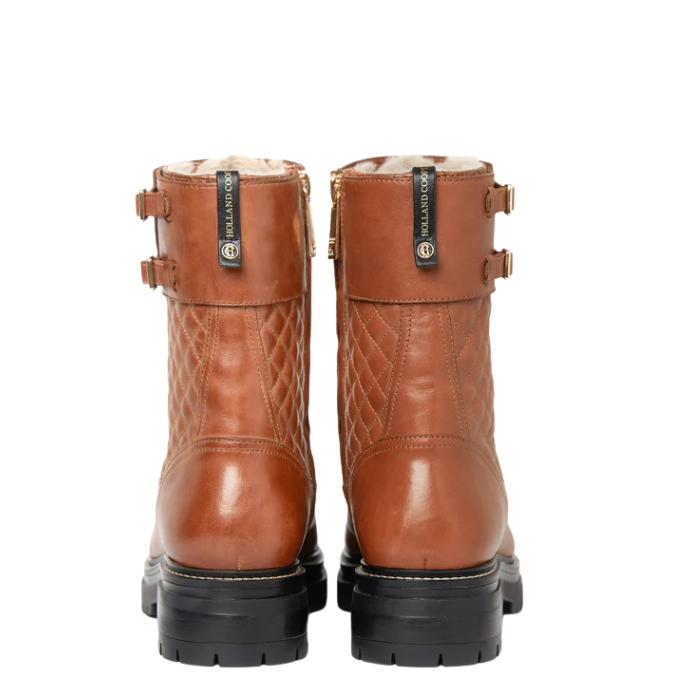 Pair of brown leather boots with visible Holland Cooper brand logo on a white background