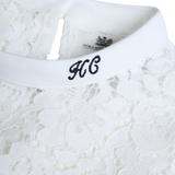 Lace fabric with HC embroidered detail on a white background