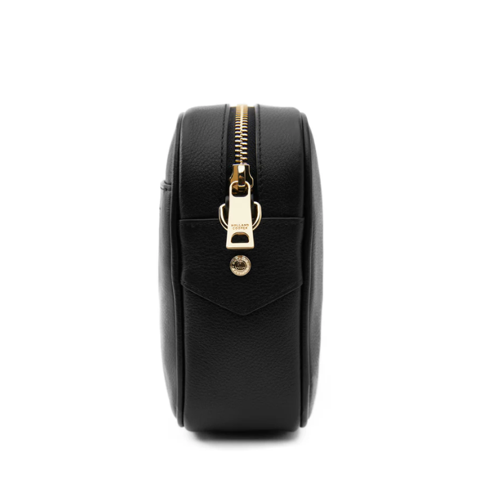 Black round pouch with gold zipper on a white background