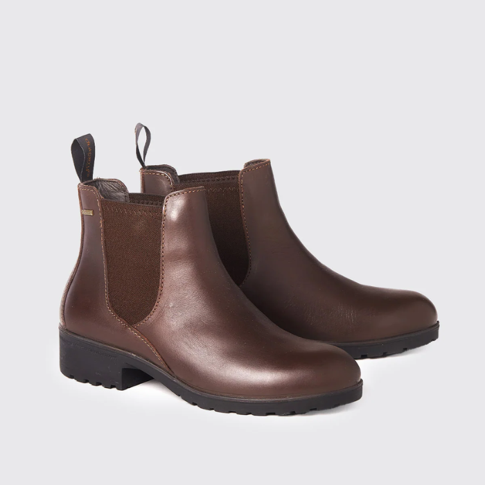 Pair of mahogany brown leather boots on a light grey background