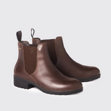 Pair of mahogany brown leather boots on a light grey background