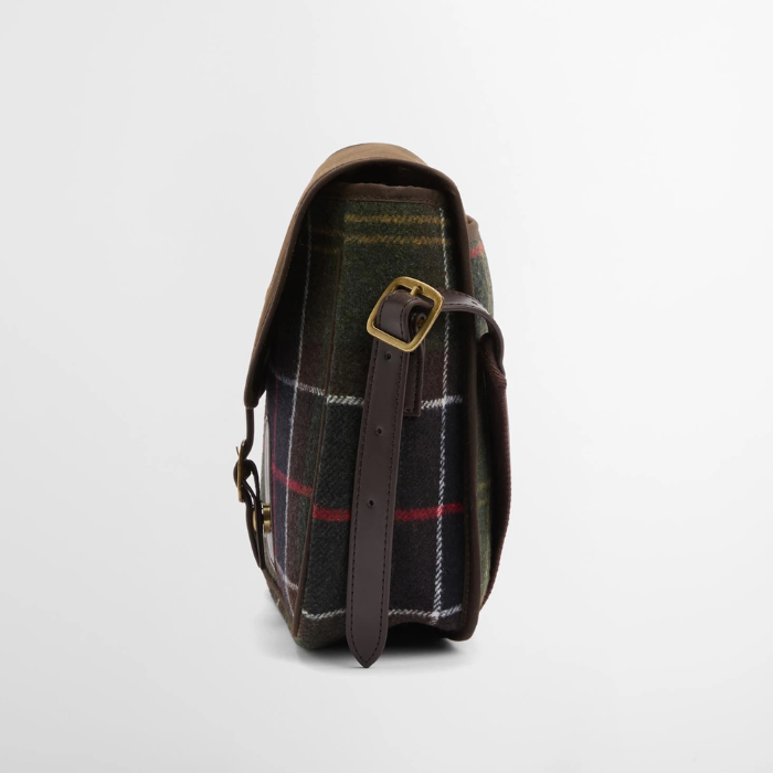 Tartan bag with leather strap and gold buckle on a light grey background
