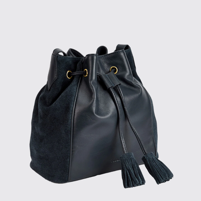 navy drawstring pouch style bag with suede tassels on a white background