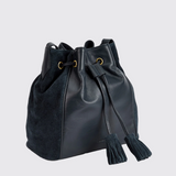 navy drawstring pouch style bag with suede tassels on a white background