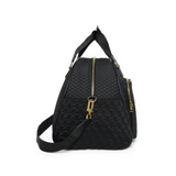 Black quilted bag with gold zippers on a white background