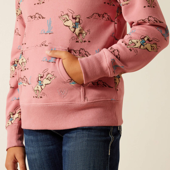 Pink hoodie with  horse print worn by a person on a beige background