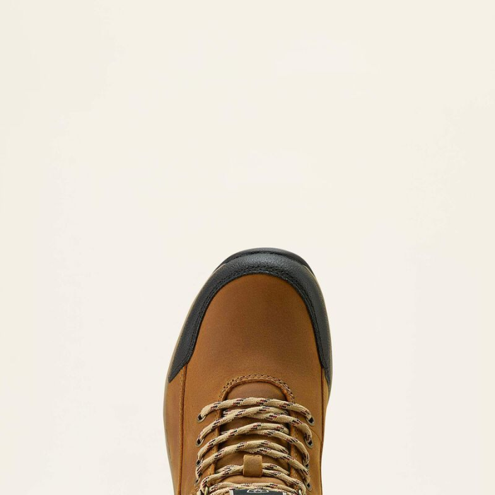 Brown leather boot with black accents on a beige background