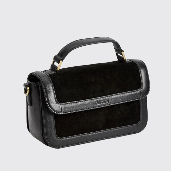 black leather and suede boxy handbag against a grey background