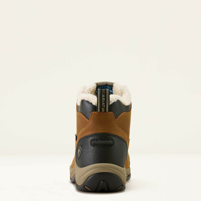 Brown winter boot with black sole on a white background