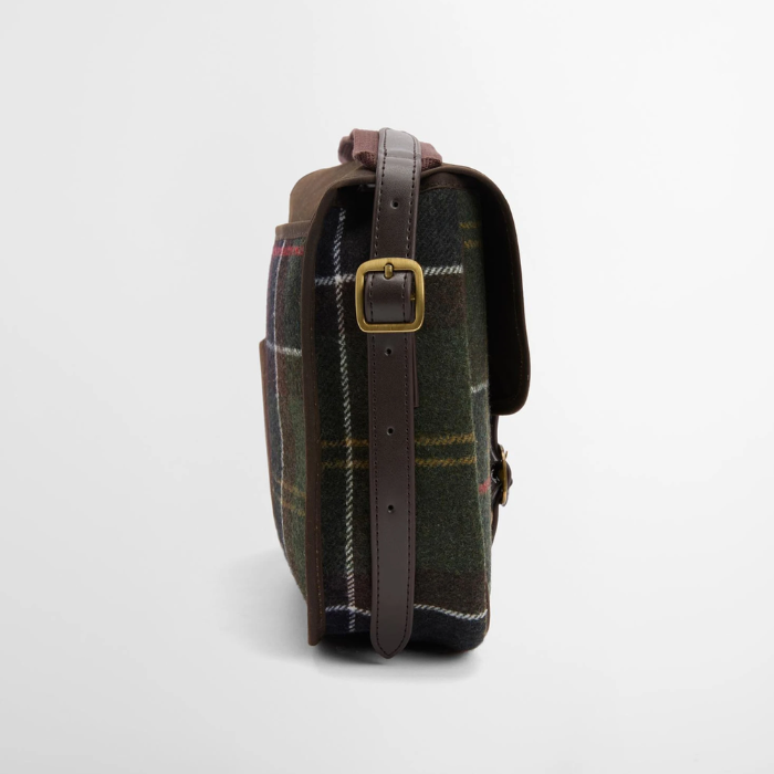 Tartan bag with brown strap and buckle on a light grey background