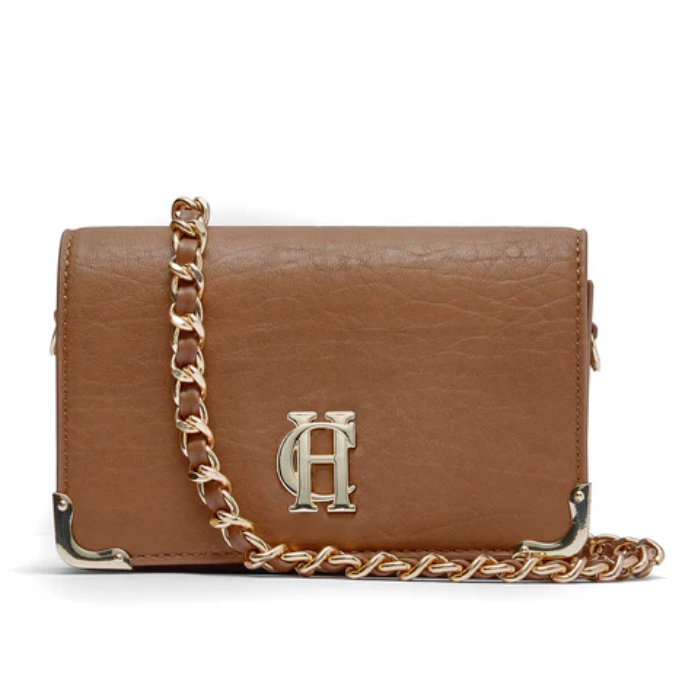 Brown leather handbag with gold chain strap and HC detailing on a white background
