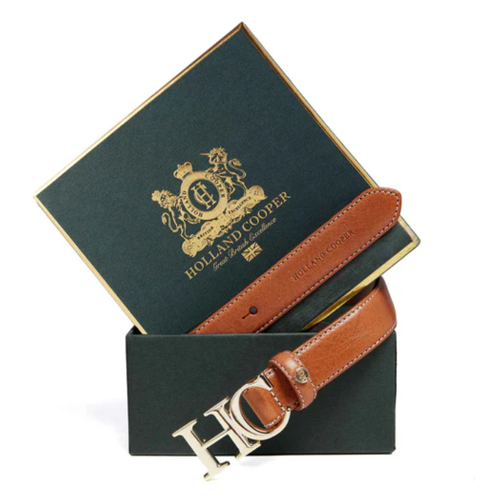 Brown leather belt with gold hardware and Holland Cooper box on a white background