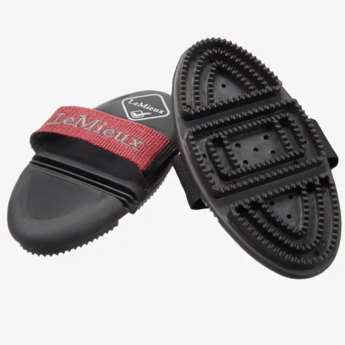 Black grooming brush with red strap labelled 'LeMieux' on a white background