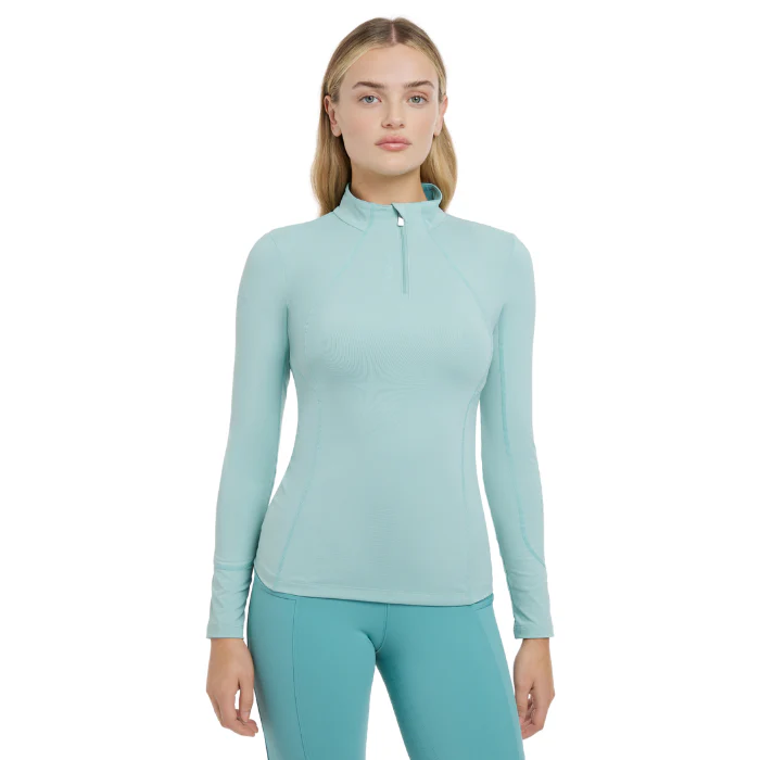 Woman wearing an aqua blue riding outfit on a white background