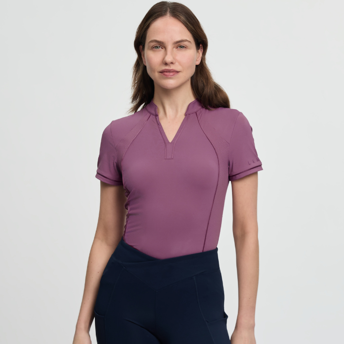 Woman wearing a pink short-sleeve top on a light grey background