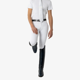 Man wears a pair of white breeches and black riding boots on a white background