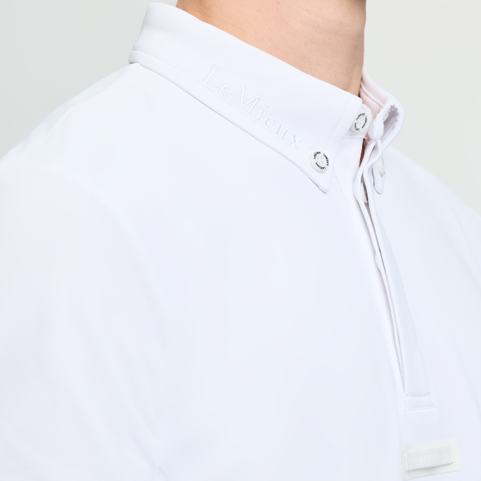 White shirt with LeMieux embroidery on the collar on a plain background