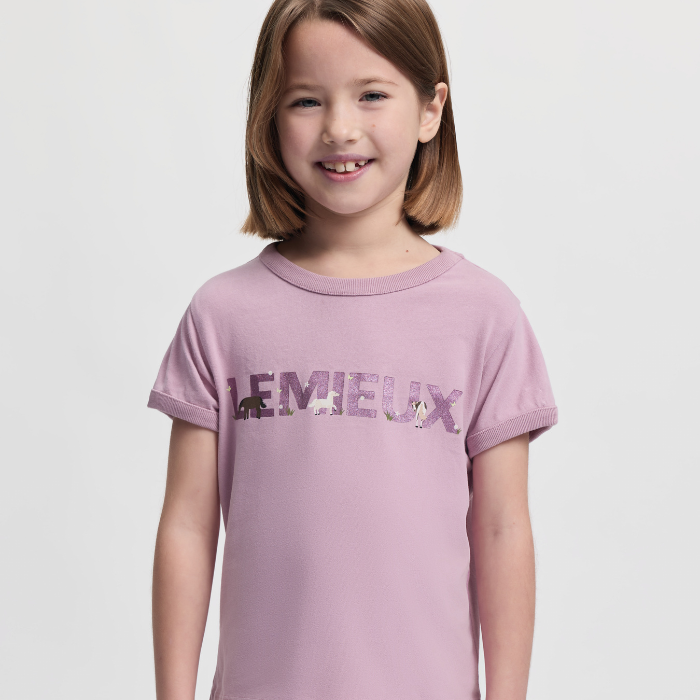 Young girl wearing a pink t-shirt with 'LEMIEUX' branding on a light grey background