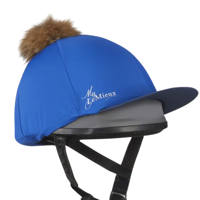 Blue equestrian helmet with brown fur pom-pom and 'My Lemieux' logo on a white background