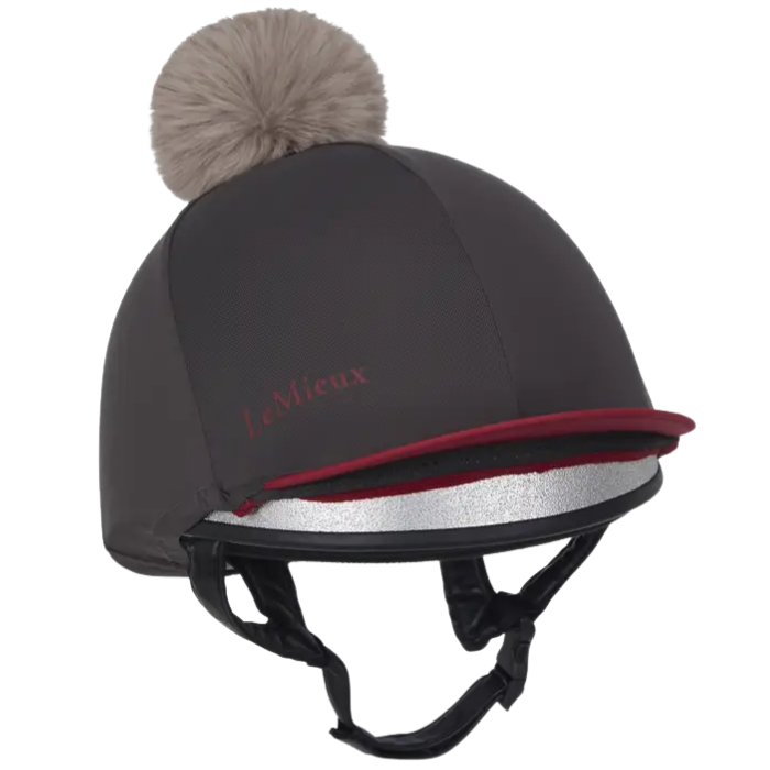 Dark and red equestrian helmet with brown fur pom-pom and 'My Lemieux' logo on a white background