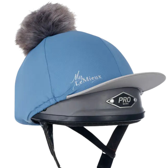 Ice blue equestrian helmet with brown fur pom-pom and 'My Lemieux' logo on a white background