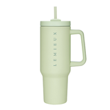 Light yellow-green tumbler with handle and straw on a white background