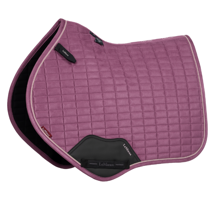 Pink quilted saddle pad with black accents on a white background