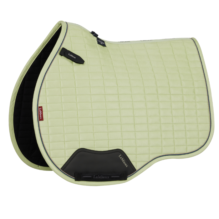 Yellow quilted saddle pad on a white background