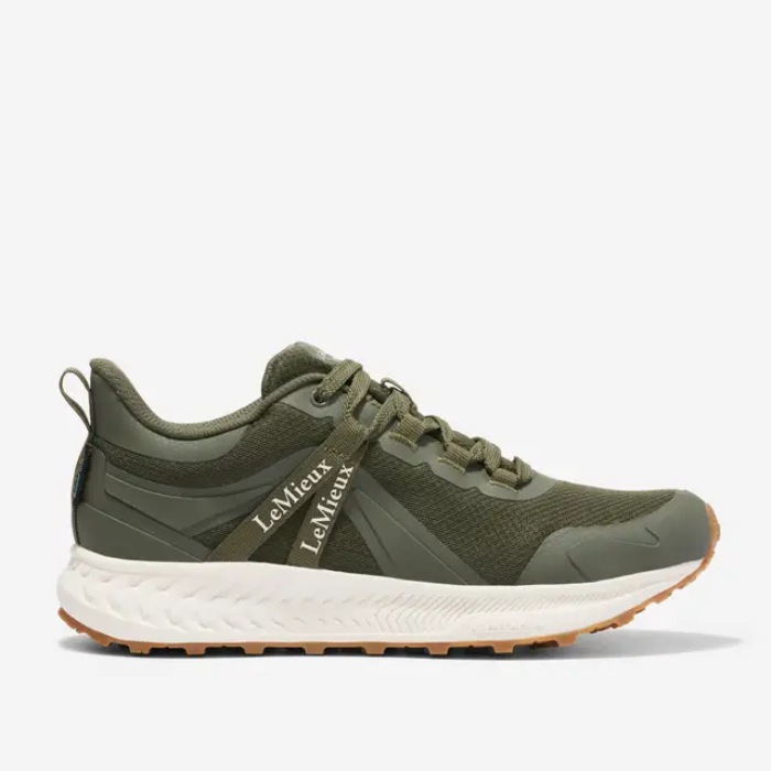 Green athletic shoe with white sole on a light grey background