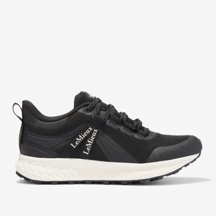 Black running shoe with white sole on a light grey background