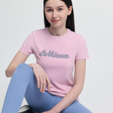Person wearing a pink t-shirt with 'LeMieux' logo sitting on a white background