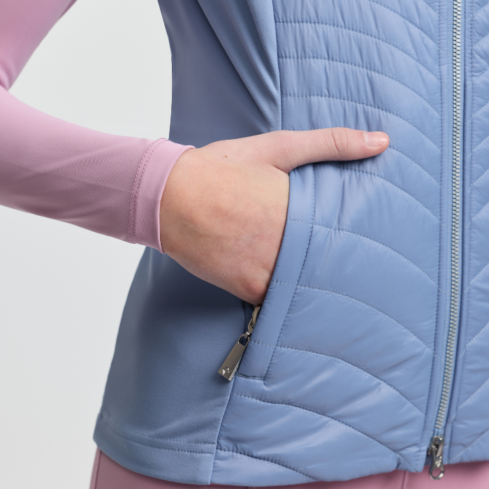 Light blue quilted jacket with a hand in the pocket on a white background