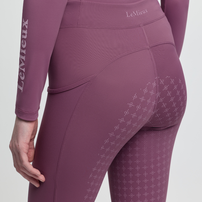 Pink leggings with a subtle pattern on a white background