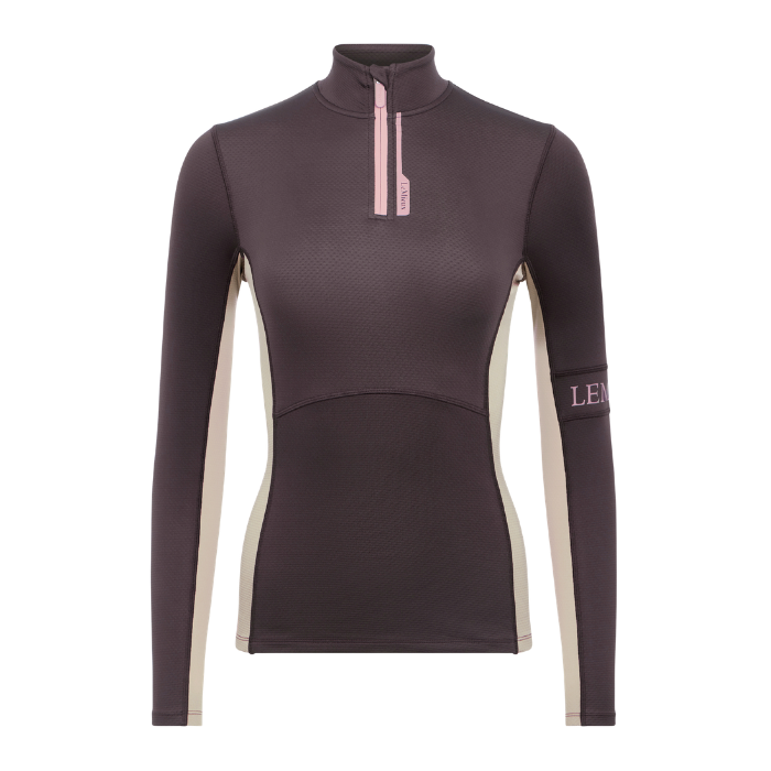LeMieux AW26 Matilda Mid Layer Variant Colour Cocoa.
A women's long-sleeve quarter-zip athletic top with light beige side panels and a light pink zipper pull, shown on a plain white background.