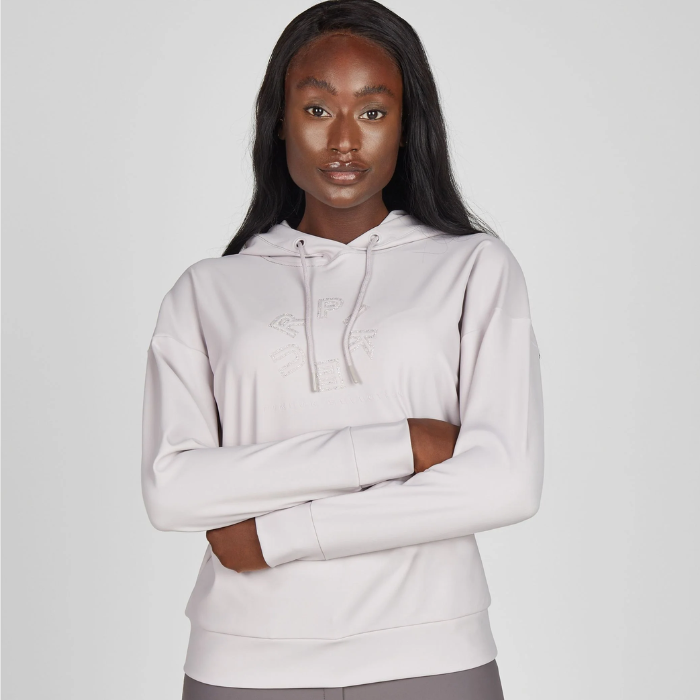 Woman wears a light lilac hoodie on a light background