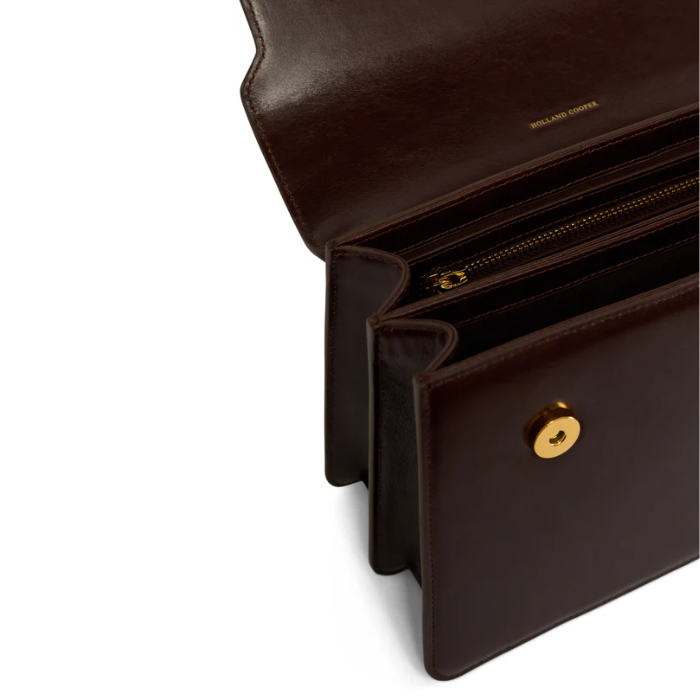 Brown leather handbag with inside zip compartment on a white background