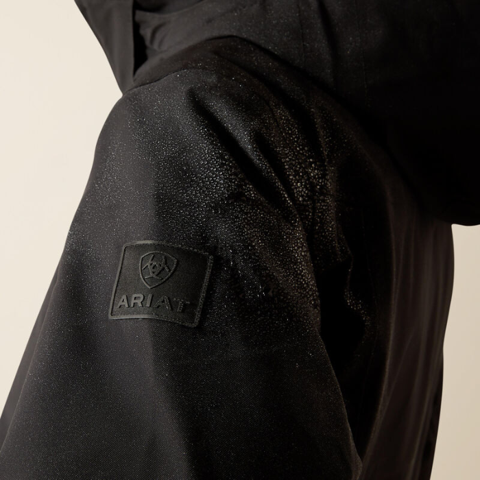 Black jacket with Ariat logo on a beige background