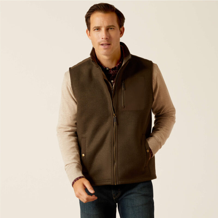 Man wearing a brown gilet over a beige shirt on a beige background
