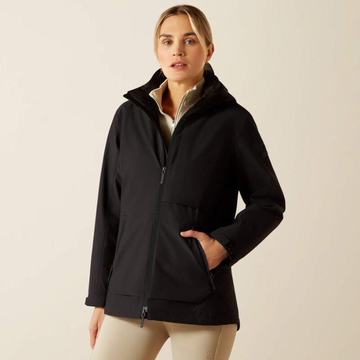 Woman wearing a black jacket on a beige background