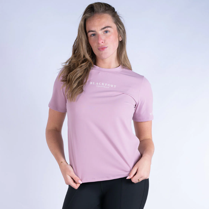 Woman wearing a pink t-shirt with 'Blackfort' logo on a white background