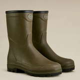 Pair of green short wellington boots on a beige background