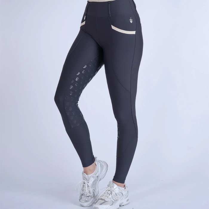 Dark grey leggings with sand elements on a grey background