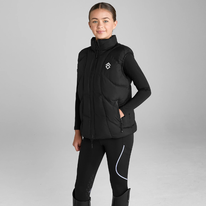 Person wearing a black puffer gilet with a logo on a grey background