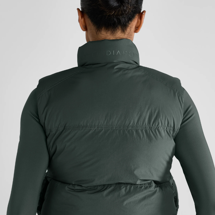 Green gilet with AZTEC DIAMOND branding on a grey background