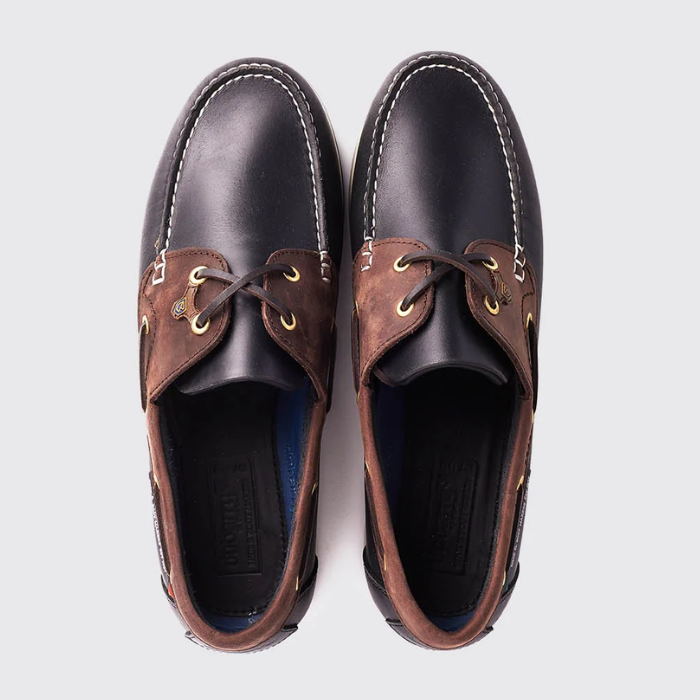 Pair of brown leather boat shoes on a light grey background