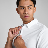 Man wearing a white polo shirt with a brand logo on a grey background